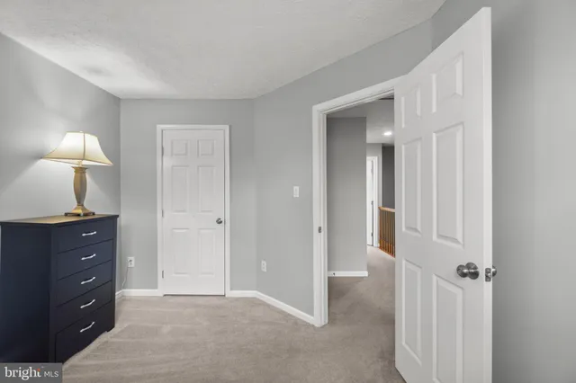 a view of a room with cabinet mirror and lamp