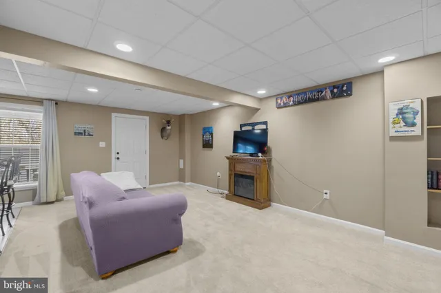 a living room with furniture a fireplace and a flat screen tv