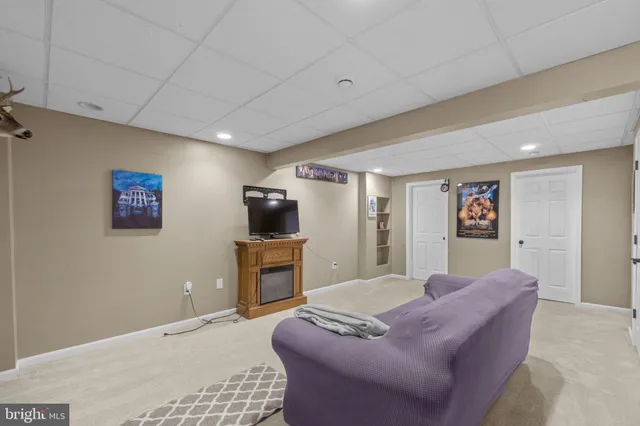 a kitchen with a table chairs and a flat screen tv