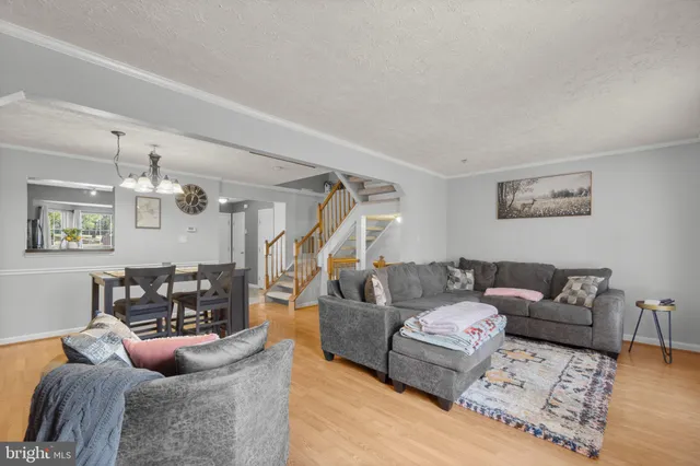 a living room with furniture and a chandelier