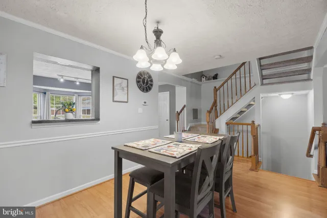 a view of a dining room with furniture and a chandelier