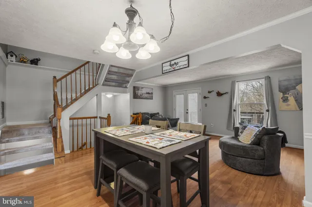 a view of a dining room with furniture wooden floor and chandelier