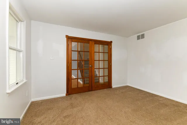 a view of a livingroom with a ceiling fan and window