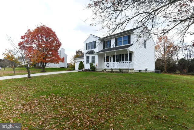 a view of a house with a yard and sitting area