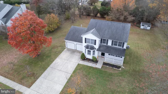 an aerial view of residential house with outdoor space and trees around
