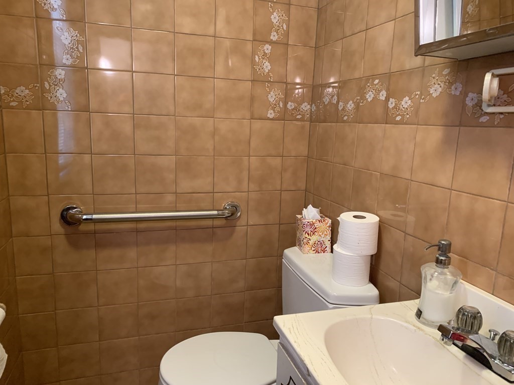 790 Broadway Everett, MA 02149 - Photo 19 of 39 a white toilet sitting next to a bathroom sink