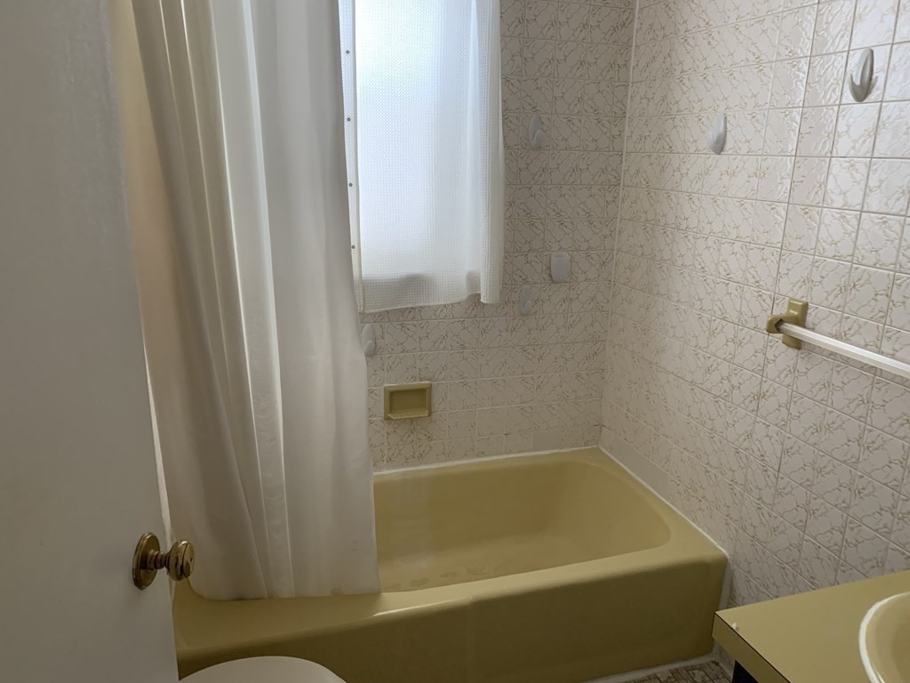 790 Broadway Everett, MA 02149 - Photo 22 of 39 a bath tub sitting next to a white toilet