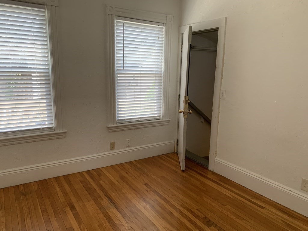 790 Broadway Everett, MA 02149 - Photo 25 of 39 a view of an empty room with wooden floor and a window