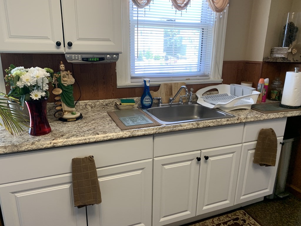 790 Broadway Everett, MA 02149 - Photo 33 of 39 a kitchen with granite countertop a sink a toilet and a granite counter tops