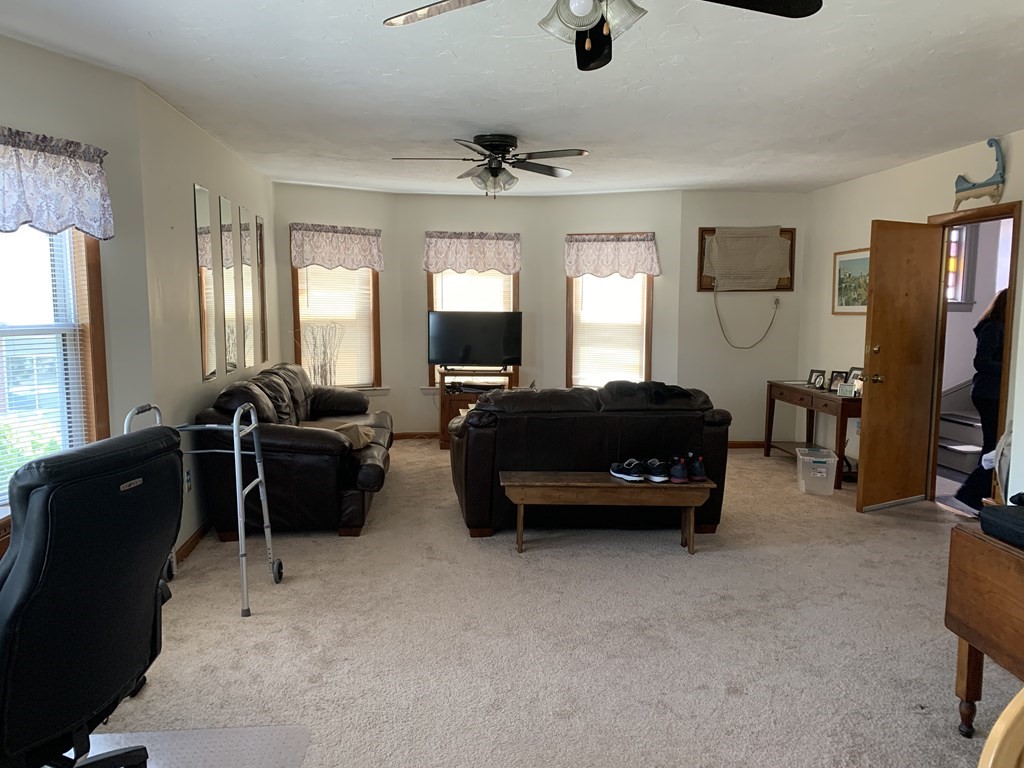 790 Broadway Everett, MA 02149 - Photo 36 of 39 a living room with furniture a flat screen tv and a window