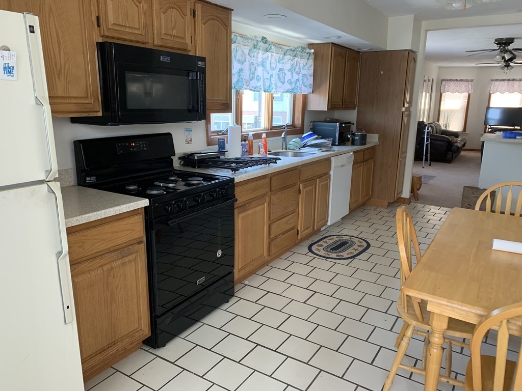 790 Broadway Everett, MA 02149 - Photo 37 of 39 a kitchen with stainless steel appliances a stove a sink and a microwave