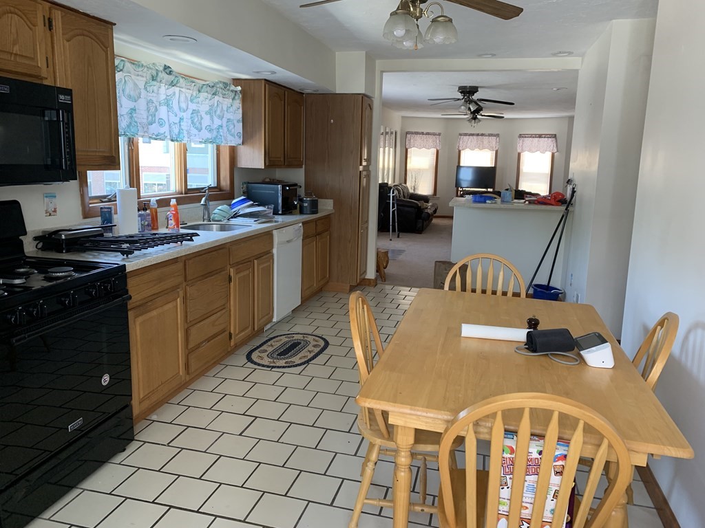 790 Broadway Everett, MA 02149 - Photo 38 of 39 a kitchen with a table chairs appliances and cabinets