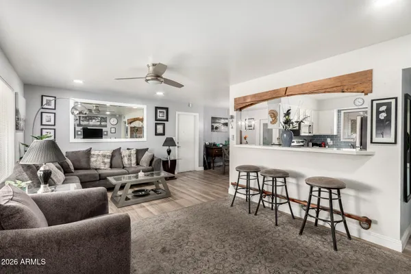 a living room with furniture and wooden floor