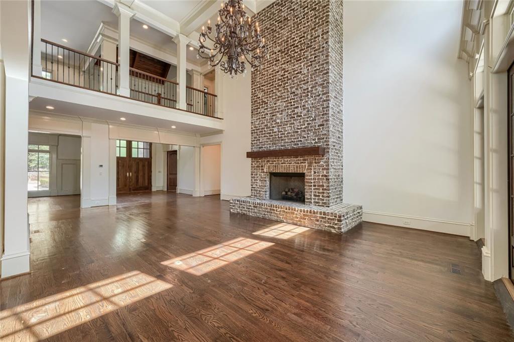 7965 Robin Road Cumming, GA 30041 - Photo 13 of 64 an empty room with wooden floor and fireplace