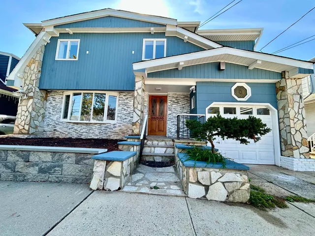 a front view of house with a garden