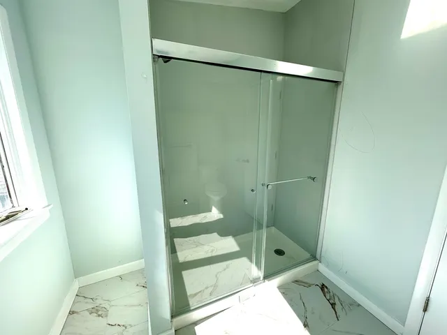 a bathroom with a glass shower door