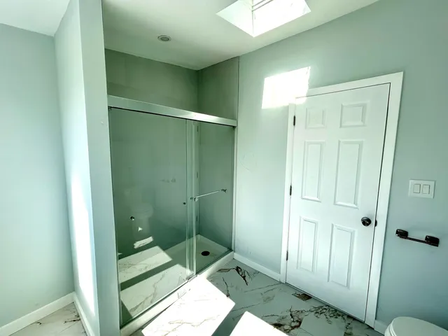 a bathroom with a shower and a sink