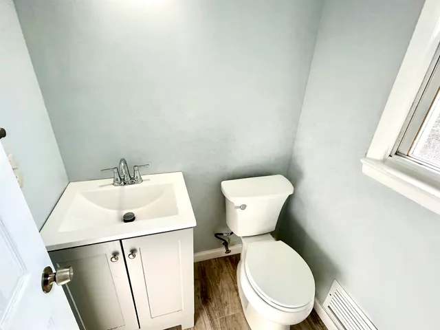 a white toilet sitting next to a white sink