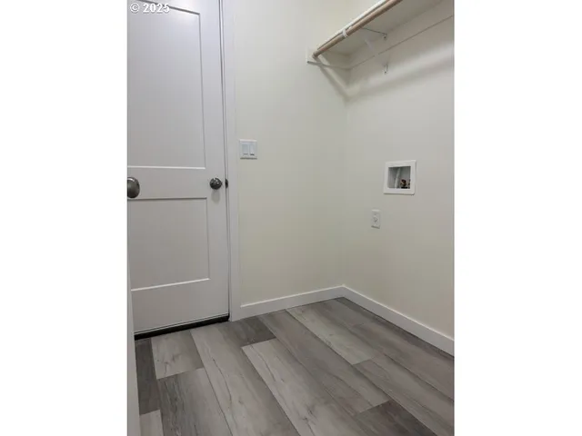 a view of a room with wooden floor