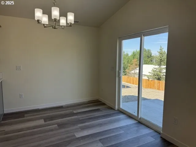 a room with wooden floor a chandelier