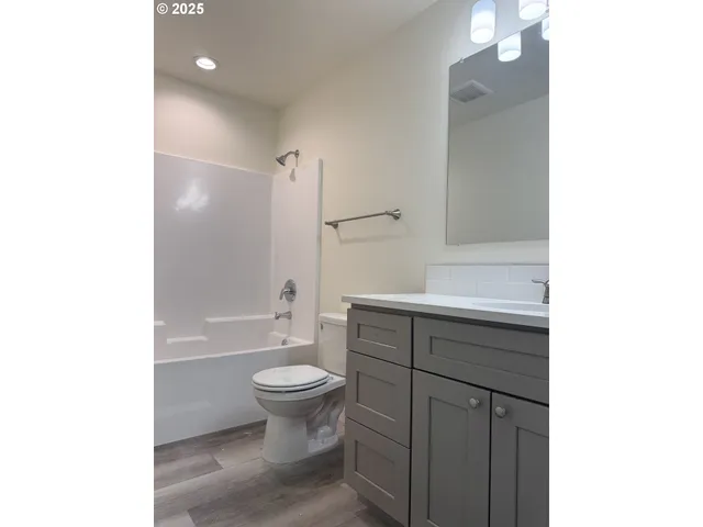 a bathroom with a sink toilet a mirror and shower