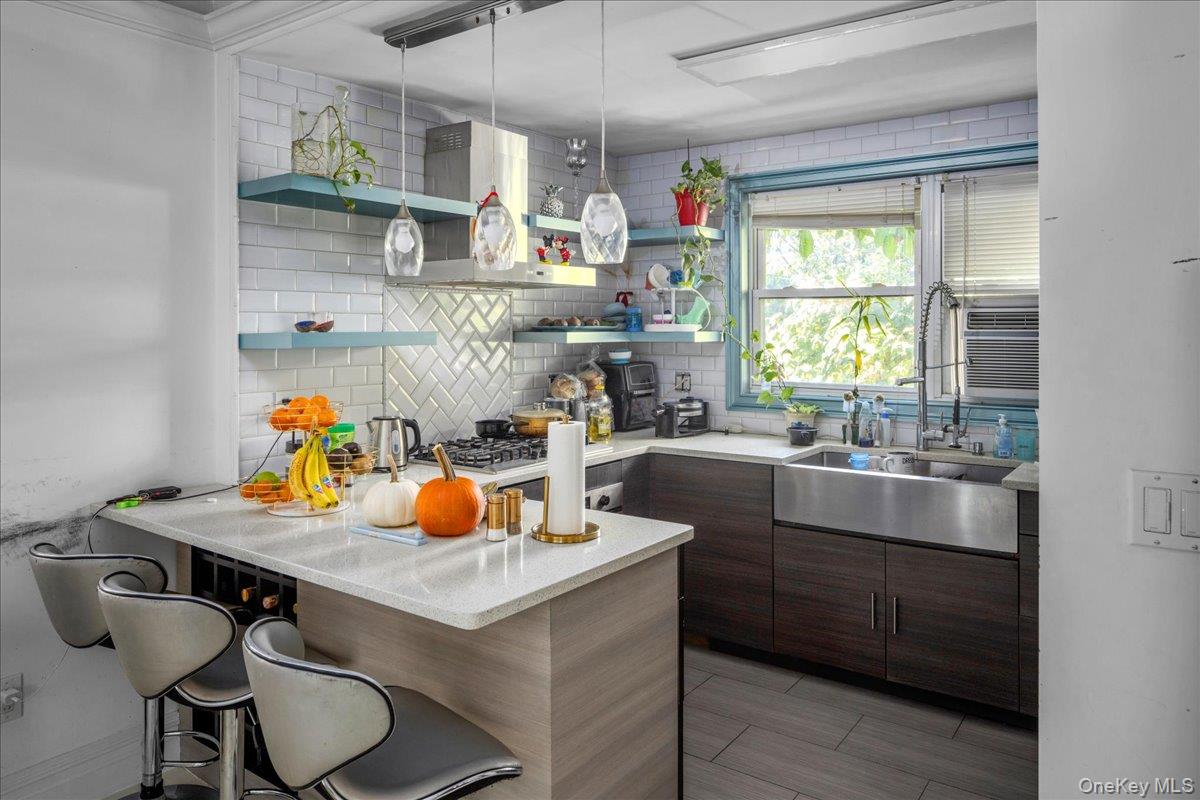 196-33 Foothill Avenue Queens, NY 11423 - Photo 11 of 34 a kitchen with a sink cabinets and window