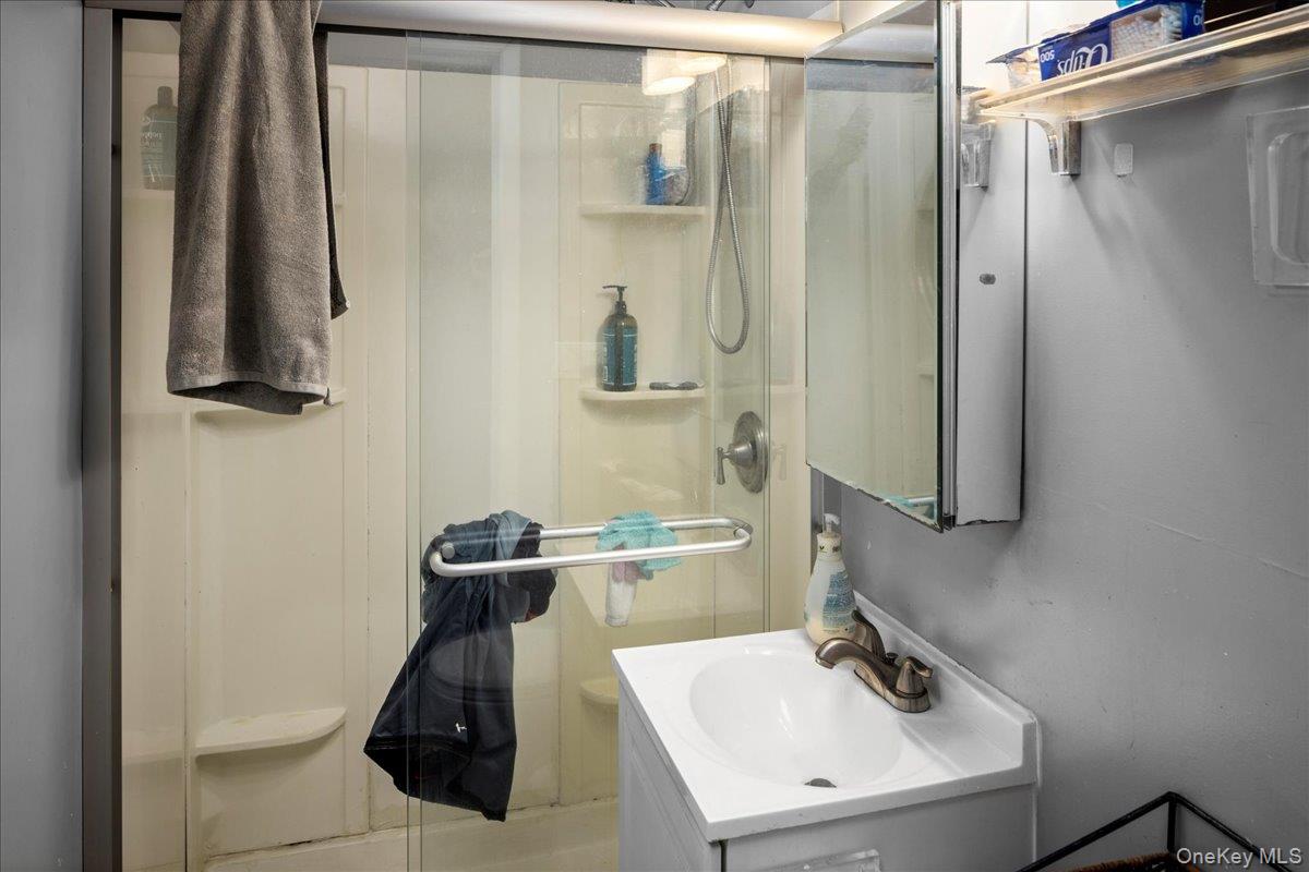 196-33 Foothill Avenue Queens, NY 11423 - Photo 17 of 34 a bathroom with a sink and mirror