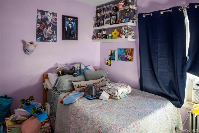 a bed room with a bed and a television