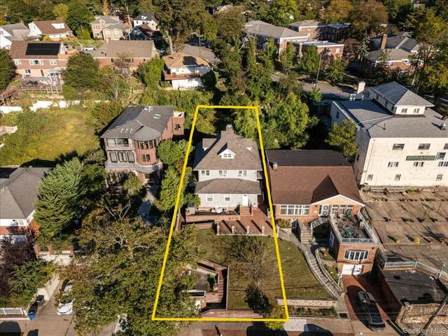 an aerial view of a residential apartment building with a yard