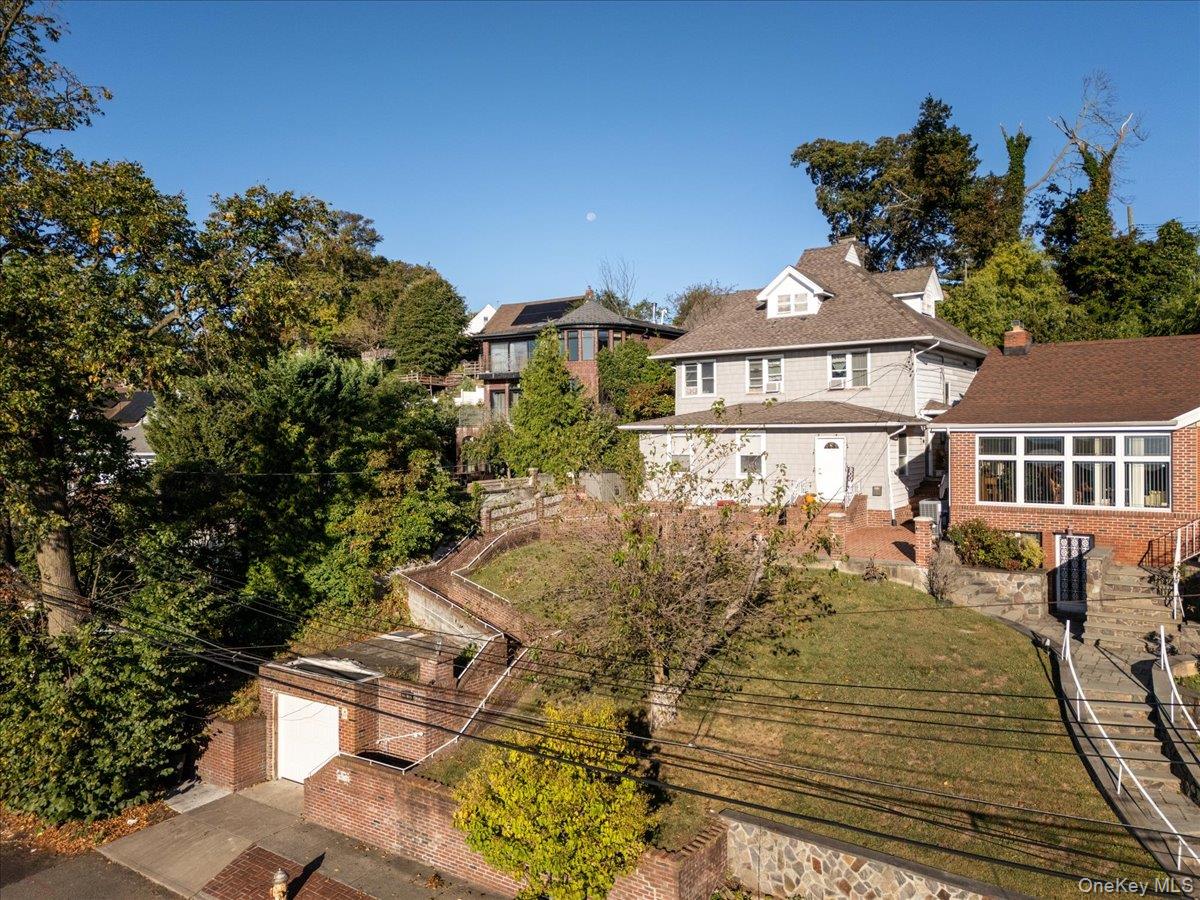 196-33 Foothill Avenue Queens, NY 11423 - Photo 25 of 34 a front view of a house with a yard