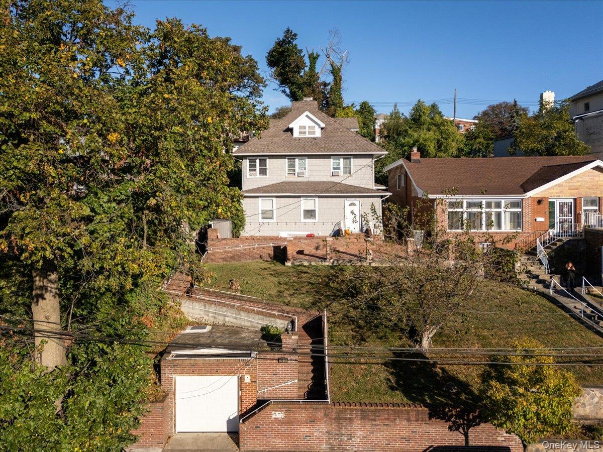 196-33 Foothill Avenue Queens, NY 11423 - Photo 26 of 34 a front view of a house with a yard