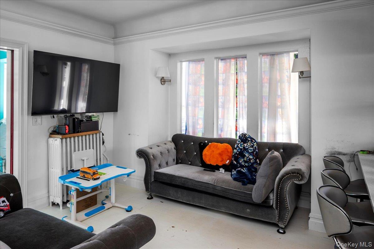 196-33 Foothill Avenue Queens, NY 11423 - Photo 10 of 34 a living room with furniture and a window