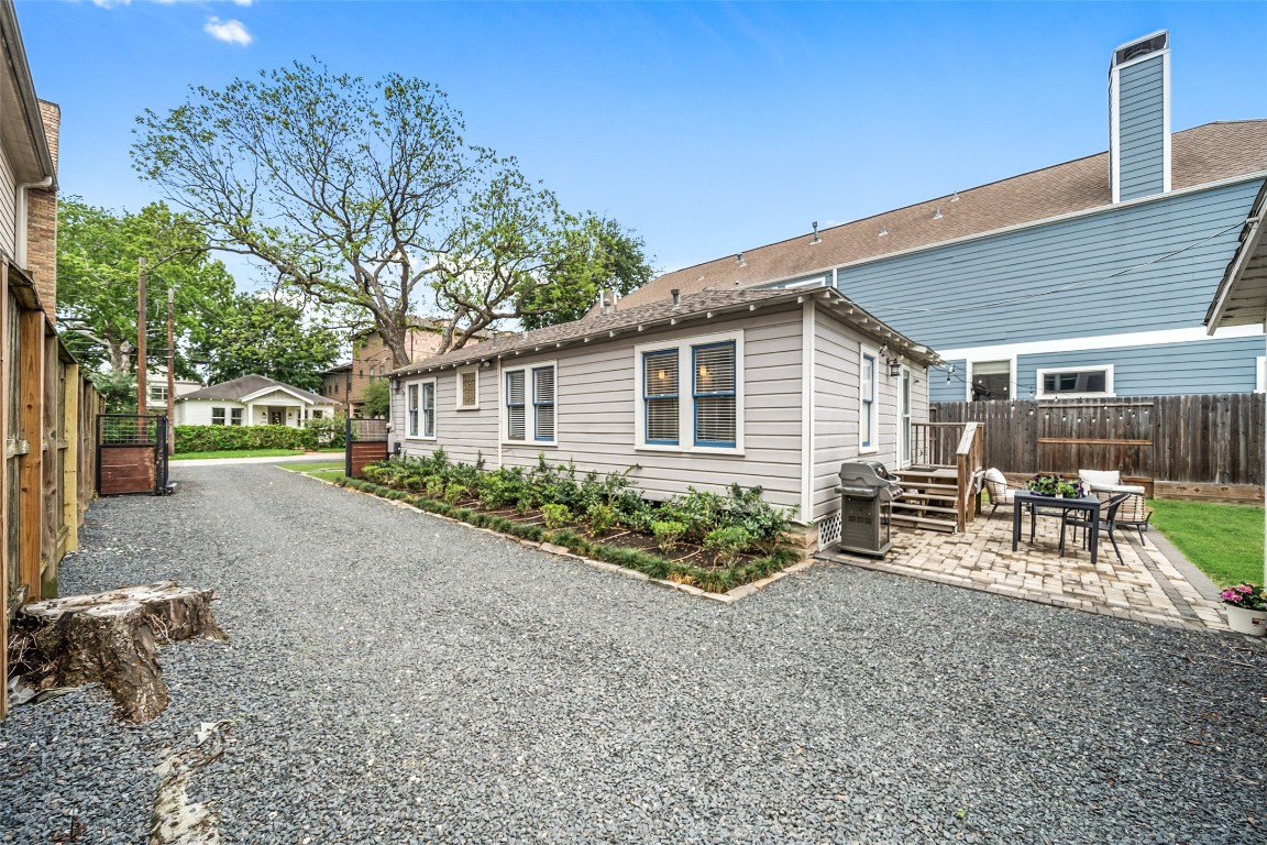 1510 Alexander Street Houston, TX 77008 - Photo 16 of 18 Deep gated gravel driveway with room for multiple vehicles and easy garage access. Parking is not an afterthought here — it's a feature.