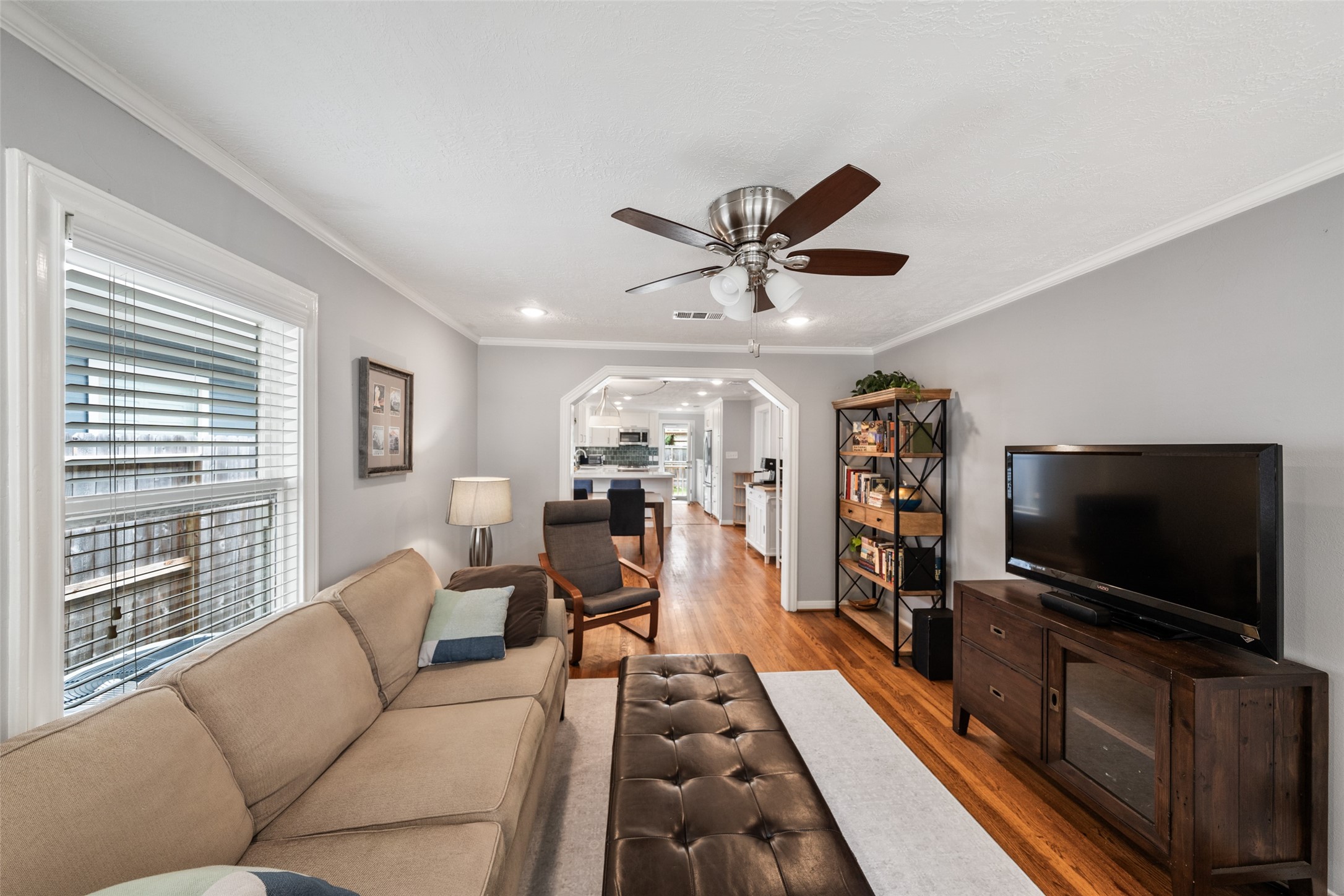 1510 Alexander Street Houston, TX 77008 - Photo 4 of 18 Original hardwood floors, crown molding, and that classic Craftsman arched passageway — the architectural detail that makes Heights bungalows worth keeping.