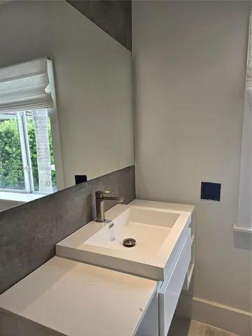 a bathroom with a sink and a washing machine