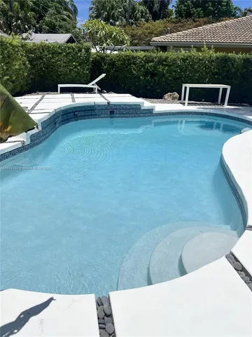 a view of swimming pool with a yard