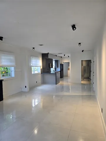 a view of a big room with windows and cabinet