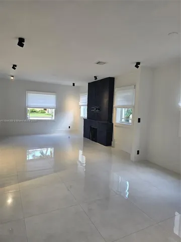 a view of a livingroom with furniture and a flat screen tv