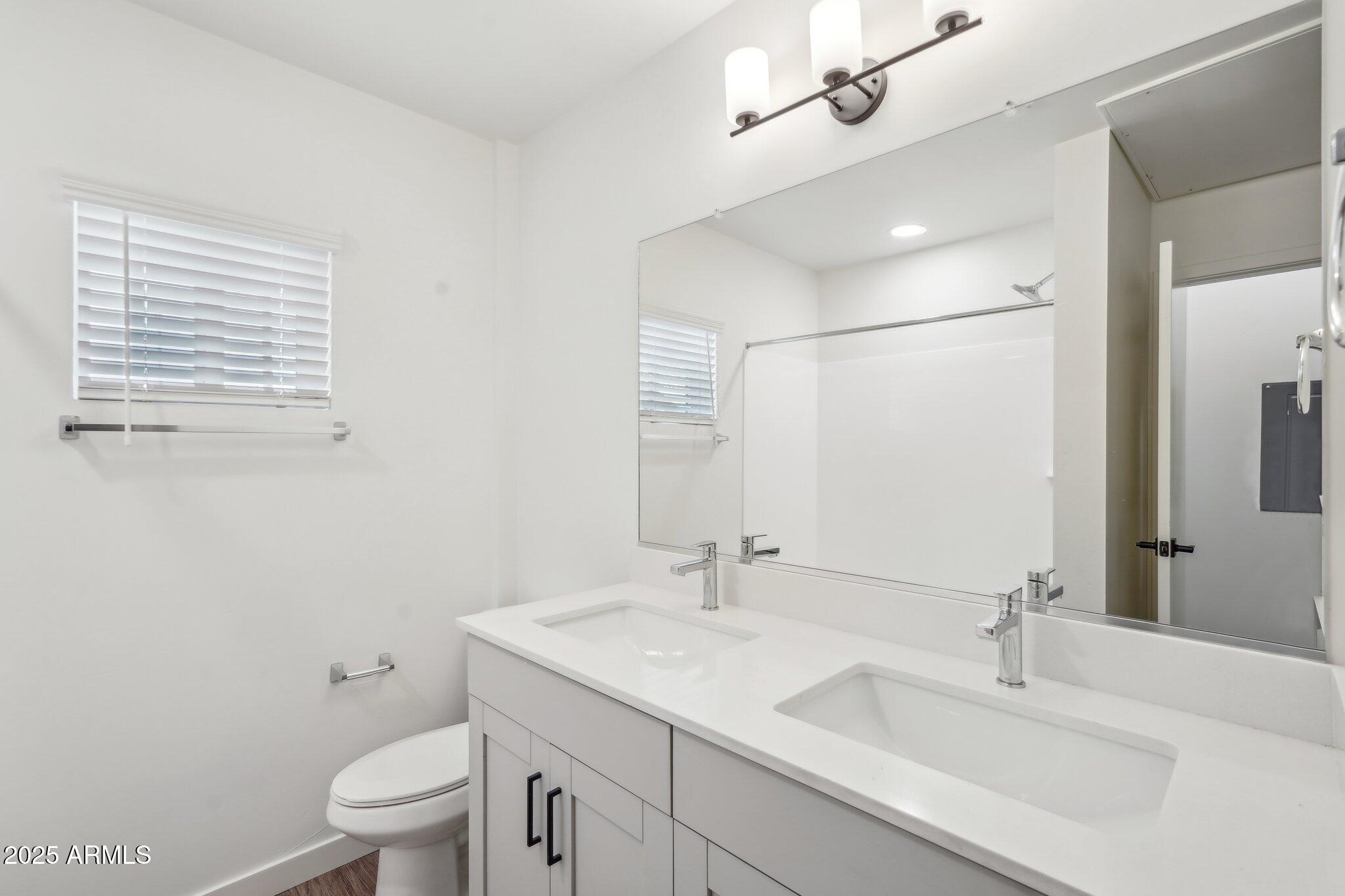 3031 West Northern Avenue, Unit 108 Phoenix, AZ 85051 - Photo 15 of 18 a bathroom with a sink a toilet and shower