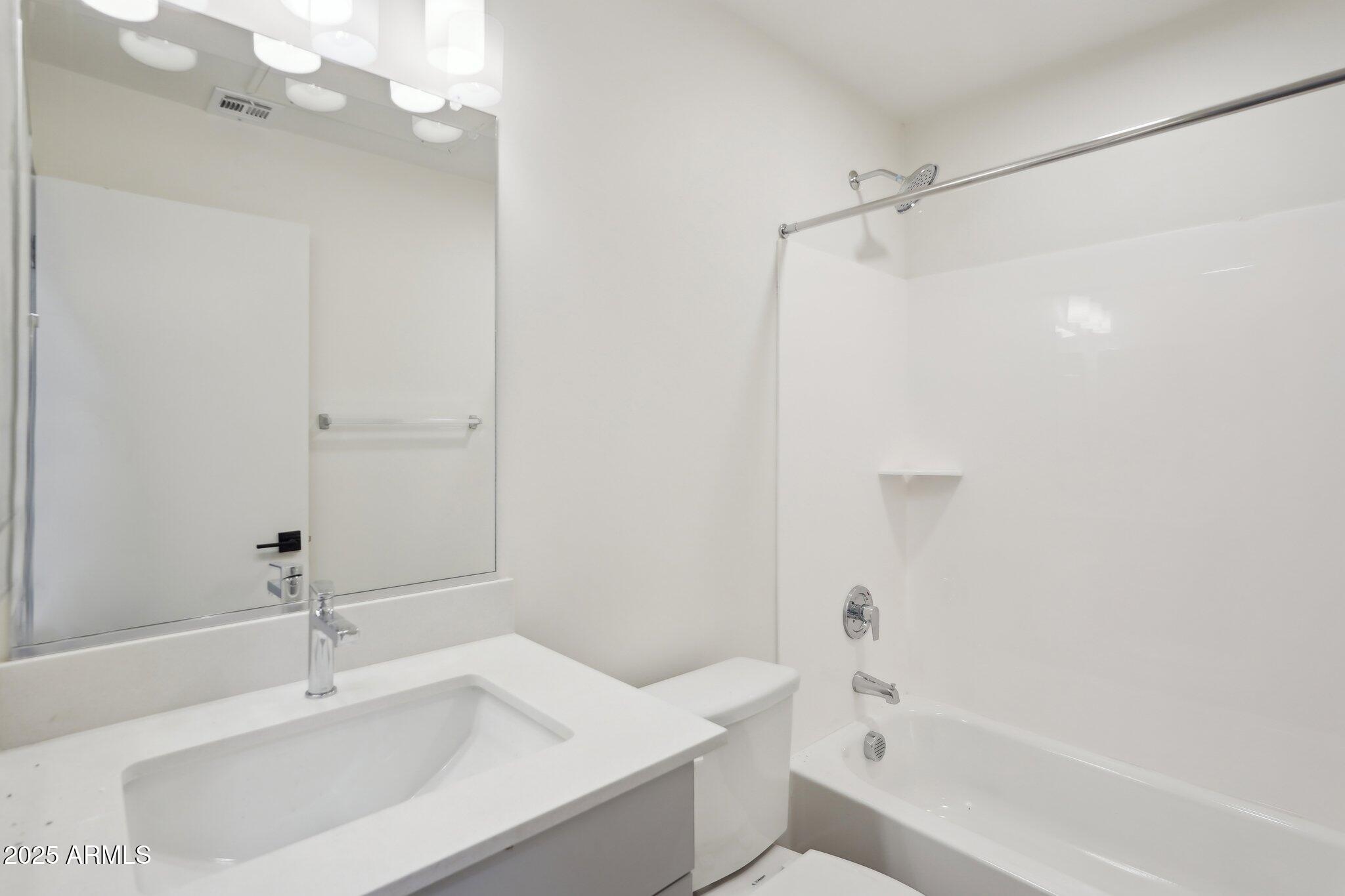 3031 West Northern Avenue, Unit 108 Phoenix, AZ 85051 - Photo 17 of 18 a bathroom with a sink a toilet and shower