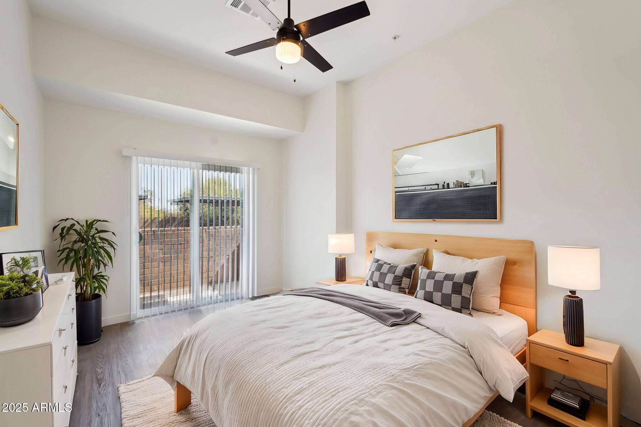 3031 West Northern Avenue, Unit 108 Phoenix, AZ 85051 - Photo 3 of 18 a bedroom with a balcony a bed and a painting on the wall