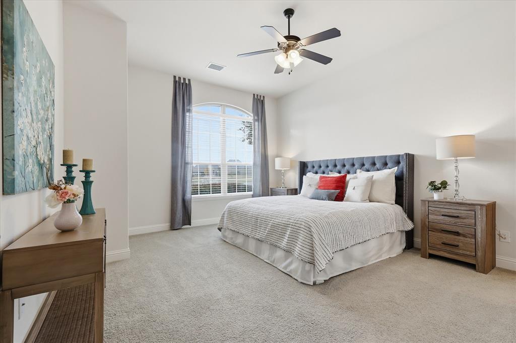 4642 Rhett Lane, Unit B Carrollton, TX 75010 - Photo 18 of 26 Bedroom featuring light carpet and a ceiling fan