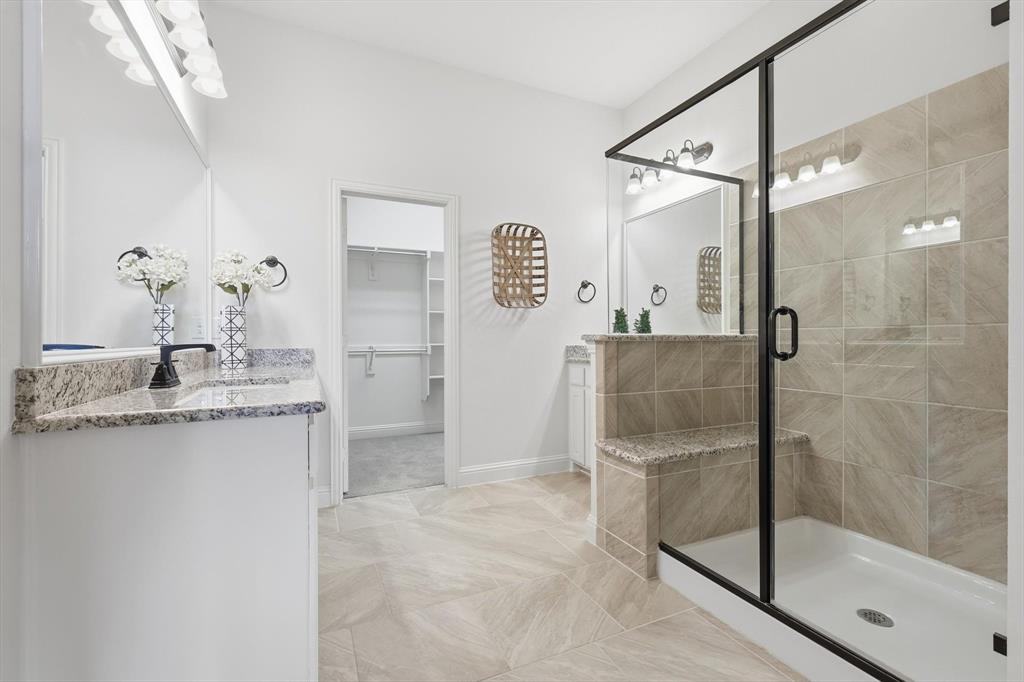 4642 Rhett Lane, Unit B Carrollton, TX 75010 - Photo 20 of 26 Bathroom with vanity, a spacious closet, and a stall shower