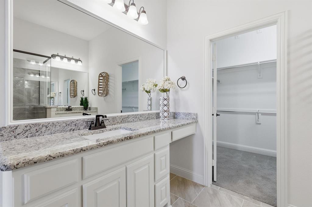 4642 Rhett Lane, Unit B Carrollton, TX 75010 - Photo 21 of 26 Bathroom with a walk in closet, vanity, and tiled shower