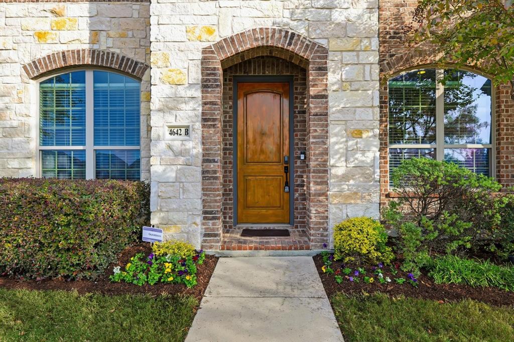 4642 Rhett Lane, Unit B Carrollton, TX 75010 - Photo 6 of 26 Doorway to property with stone siding and brick siding