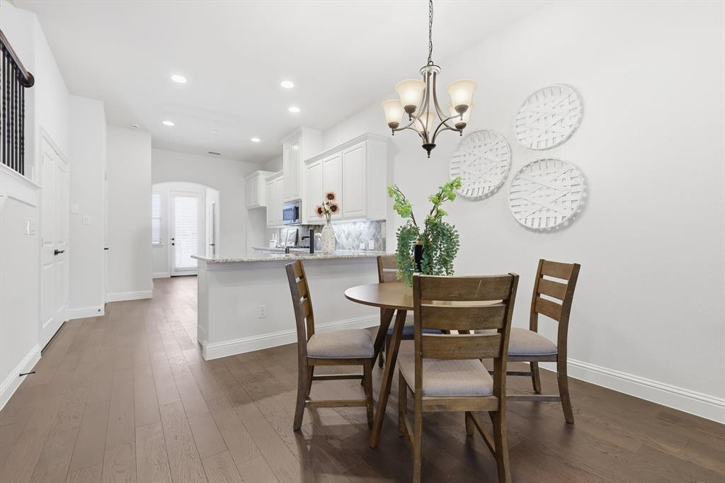 4642 Rhett Lane, Unit B Carrollton, TX 75010 - Photo 10 of 26 Dining area featuring arched walkways, dark wood-style flooring, a chandelier, and recessed lighting