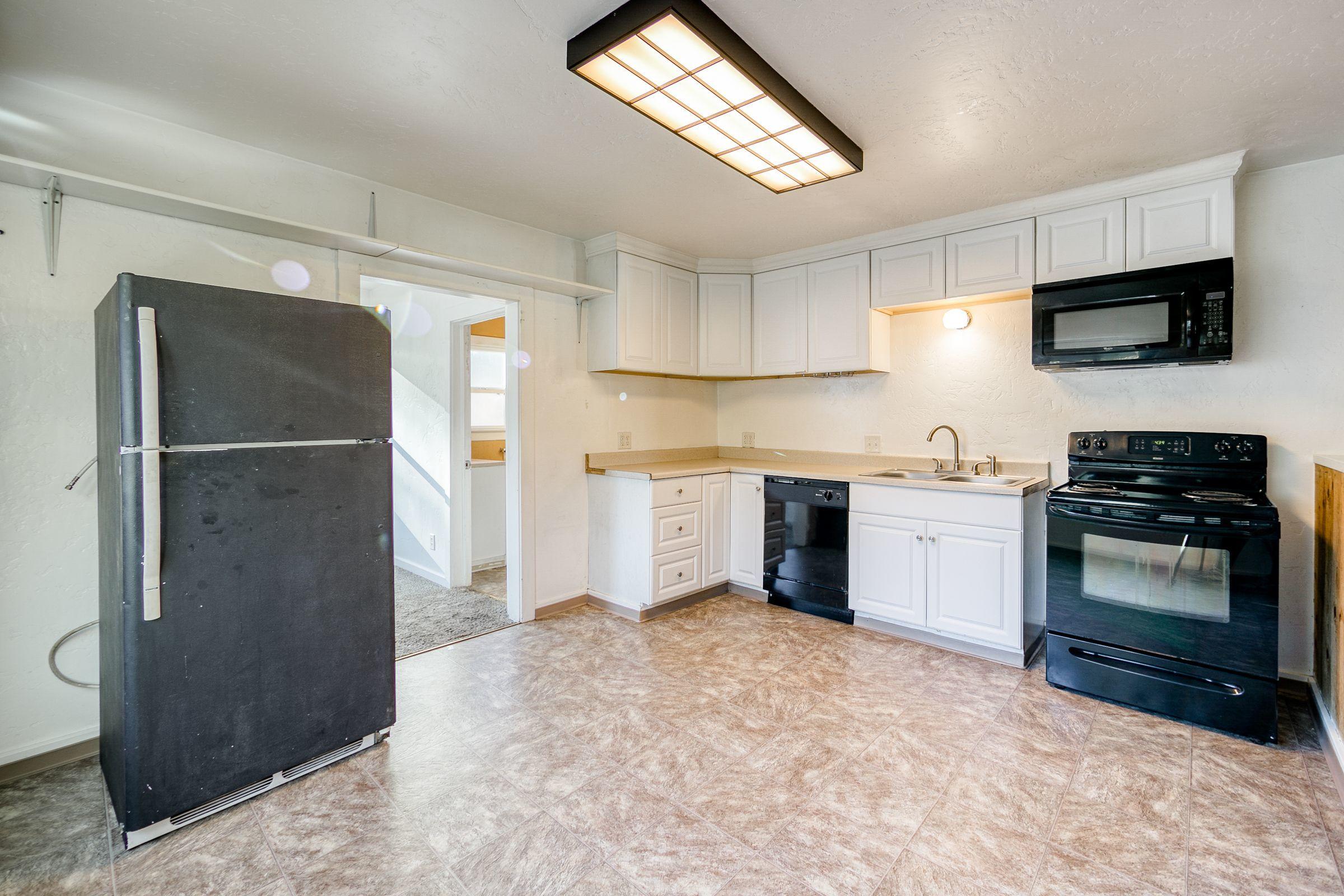 2756 Henderson Road Redding, CA 96002 - Photo 5 of 13 a kitchen with a refrigerator and a stove