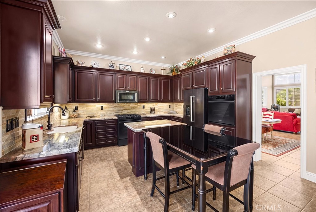 9856 Summerhill Road Rancho Cucamonga, CA 91737 - Photo 9 of 38 Another View Of The Kitchen With Granite Counter Tops & Stacked Stone Backsplash