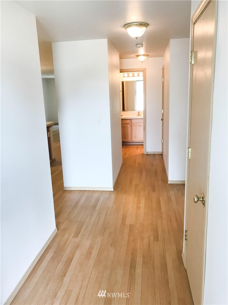 19729 Isabella Lane Southwest Rochester, WA 98579 - Photo 12 of 13 a view of a hallway with wooden floor