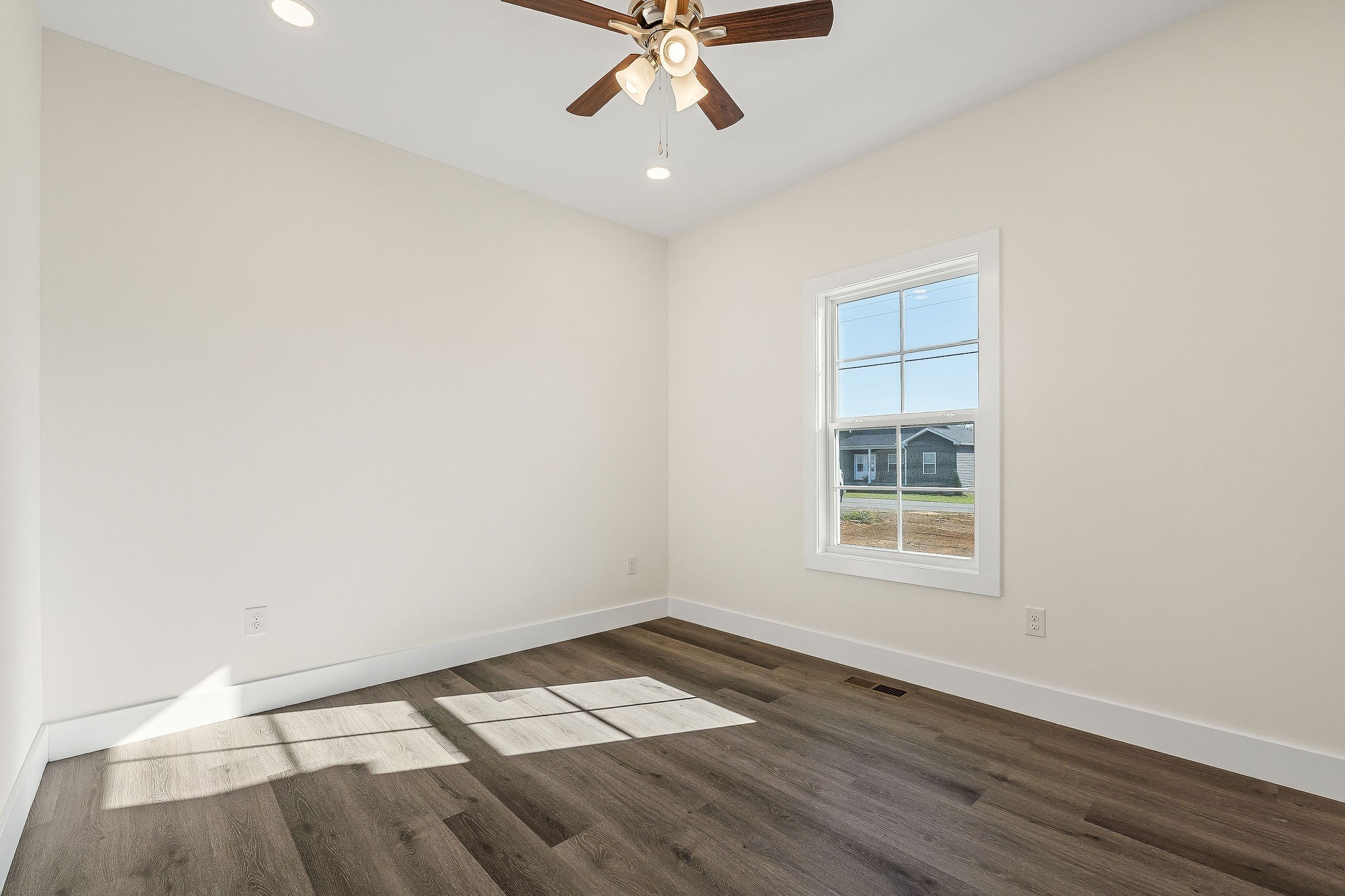 275 Johnson Chapel Road Sparta, TN 38583 - Photo 14 of 21 an empty room with wooden floor chandelier fan and windows